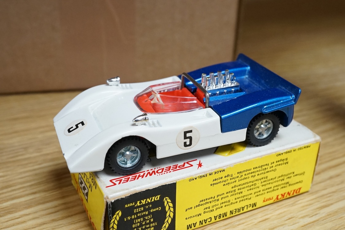 Four boxed Dinky Toys cars; a Triumph Spitfire (114) in red with cream interior, together with three Speedwheels; a Matra 630 (200) in blue, a Ferrari 312P (204) in metallic red, and a McLaren M8A Can Am (223) in white a